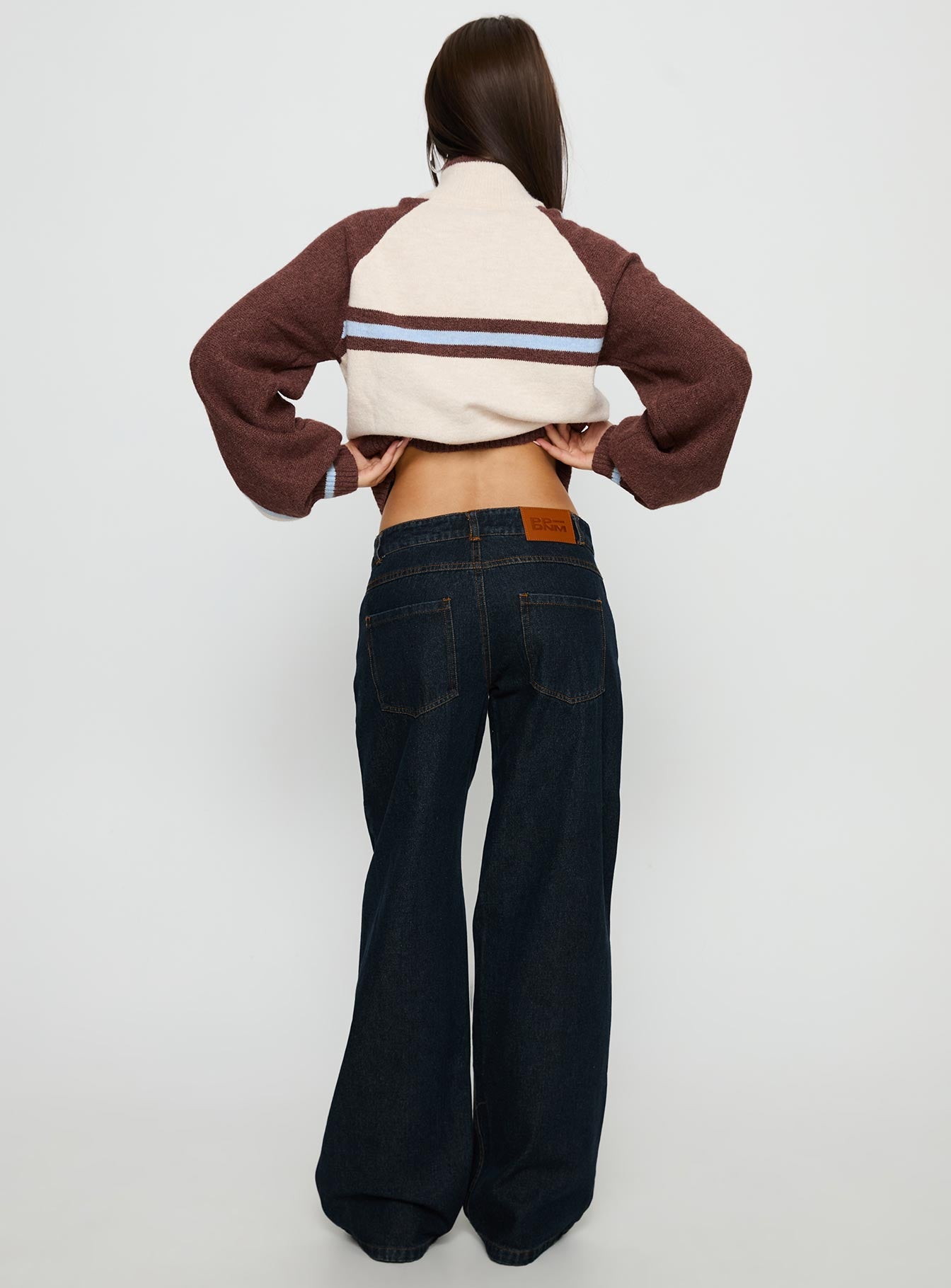 back view of model wearing Princess Polly Korinne Low Rise Bootleg Jeans Indigo Low Rise Jeans 