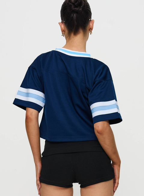back view of model wearing Princess Polly USD Football Jersey Navy Half Sleeves V-Neck 