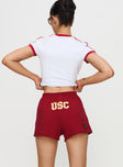 back view of model wearing Princess Polly USC Soffee Shorts Red High Waisted Shorts 