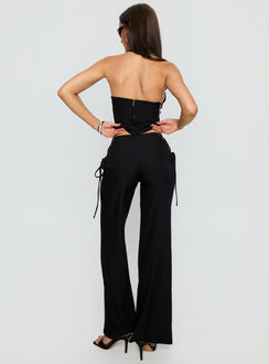 back view of model wearing Princess Polly Riane Lace Up Pants Black Mid Rise Pants 