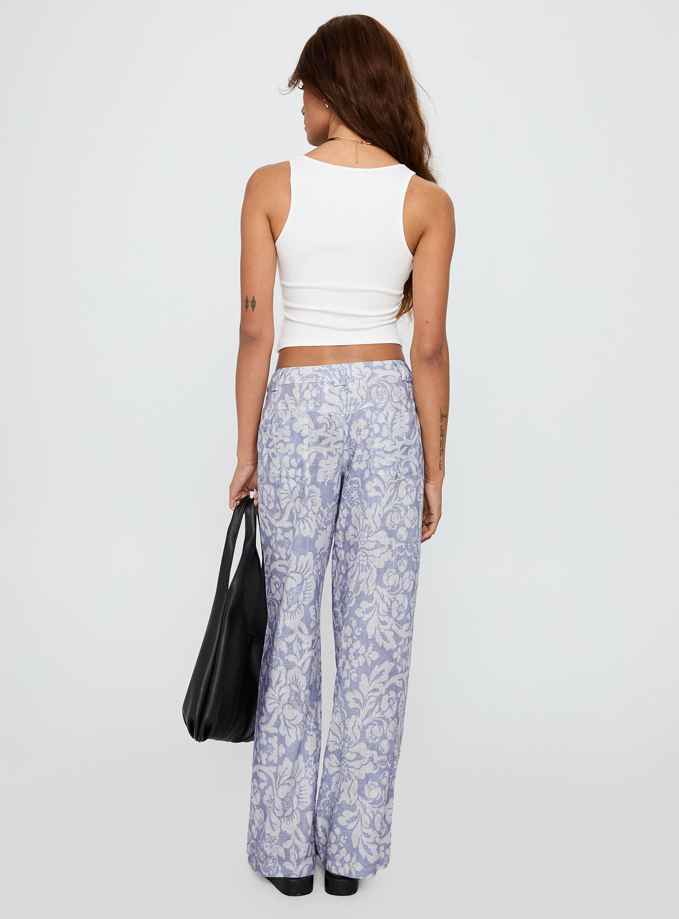 back view of model wearing Princess Polly Vendi Low Rise Pant Lilac Floral Low Rise Pants 