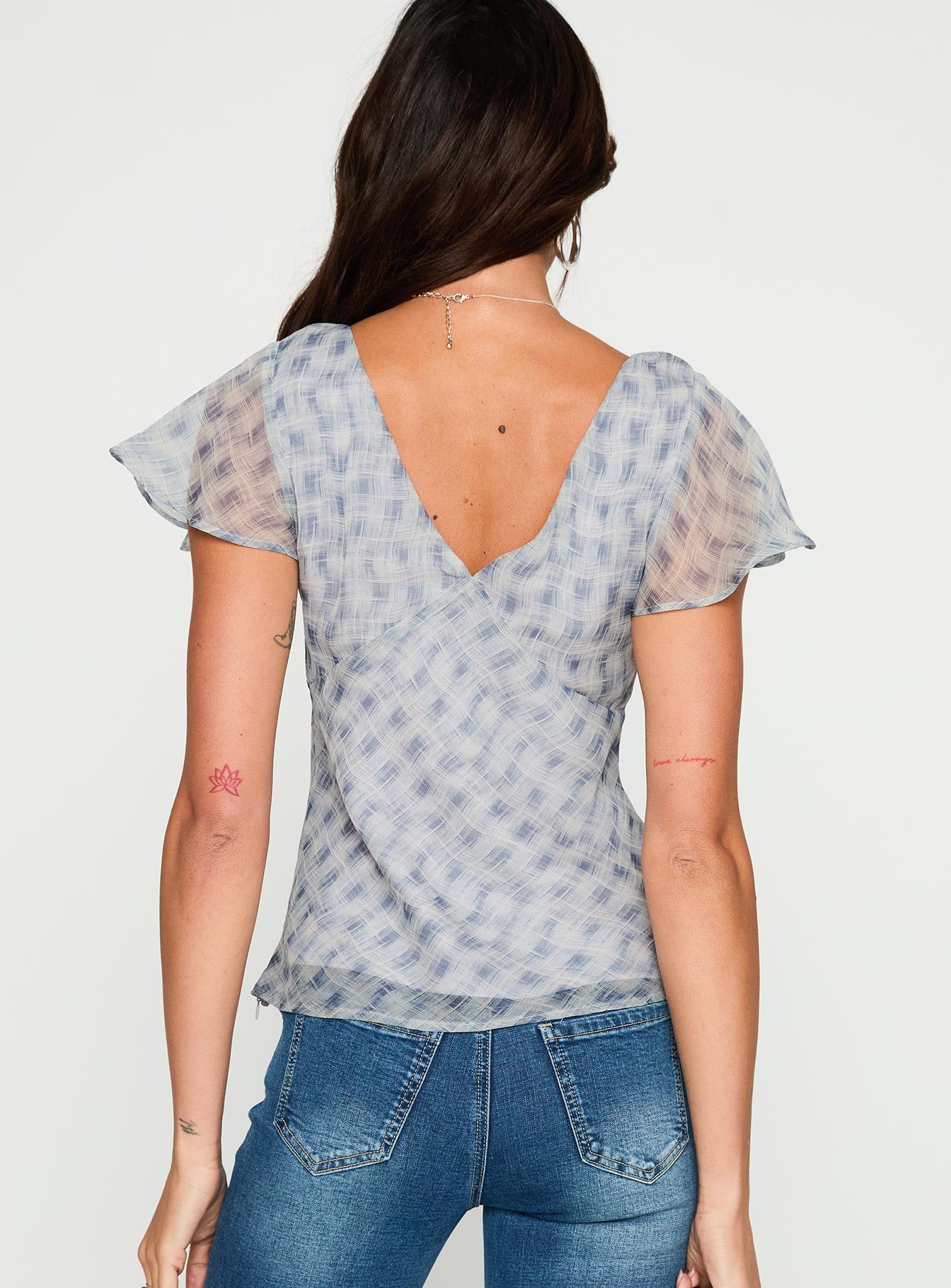 back view of model wearing Princess Polly My Last Love Top Blue Check Short Sleeves Plunger 