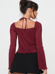 Burgundy Long sleeve top Halterneck style, v neckline, tie closure at front, split hem Good stretch, partially lined