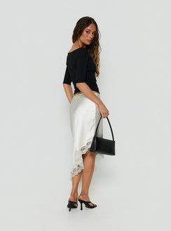 Presenting the Koletta Asymmetrical Lace Trim Satin Midi Skirt in Ivory womens-skirts back view of model wearing Princess Polly