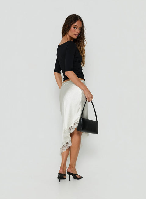 Presenting the Koletta Asymmetrical Lace Trim Satin Midi Skirt in Ivory womens-skirts back view of model wearing Princess Polly