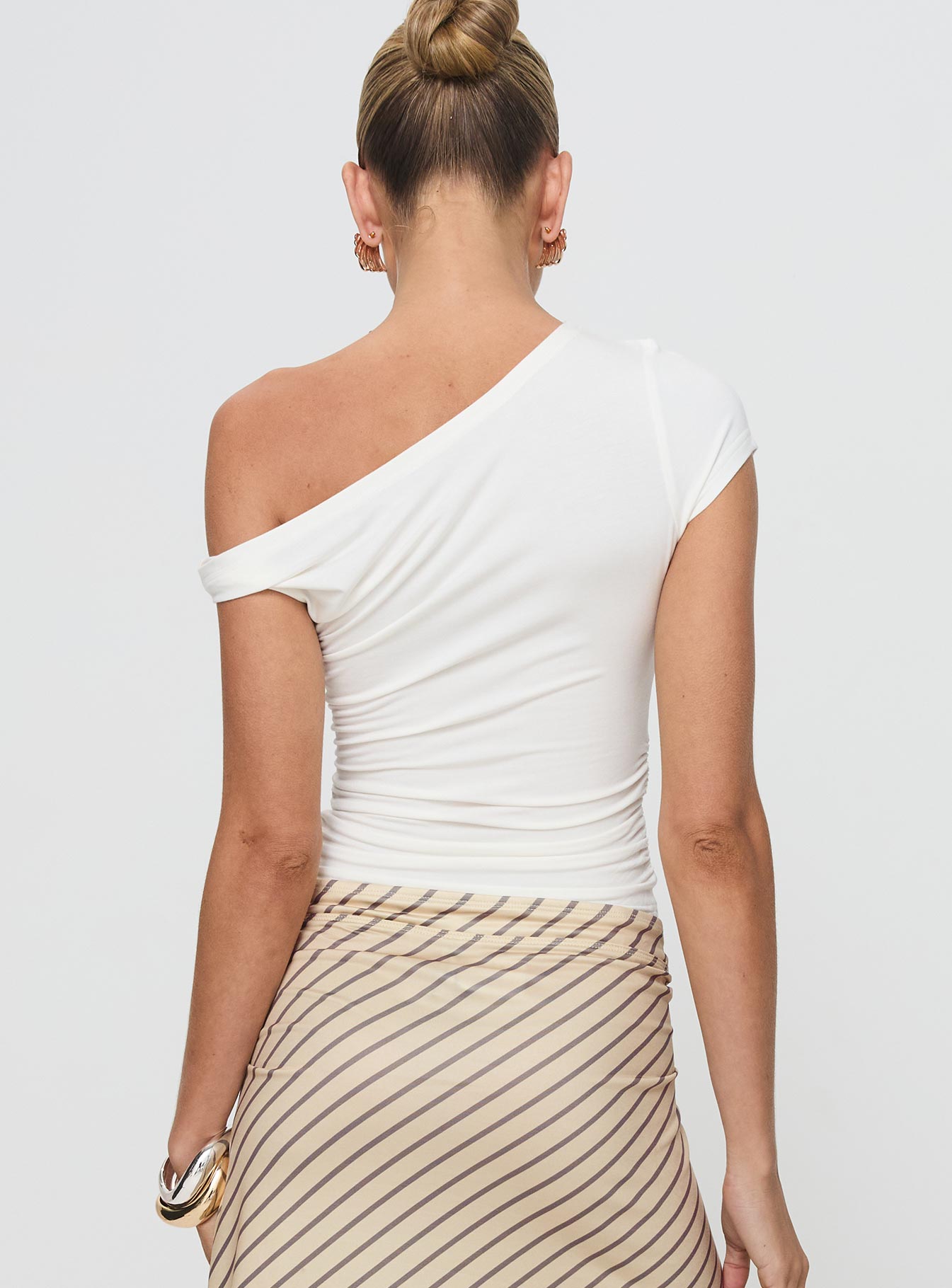 back view of model wearing Princess Polly Fabre Top White Short Sleeves Asymmetric Neckline 