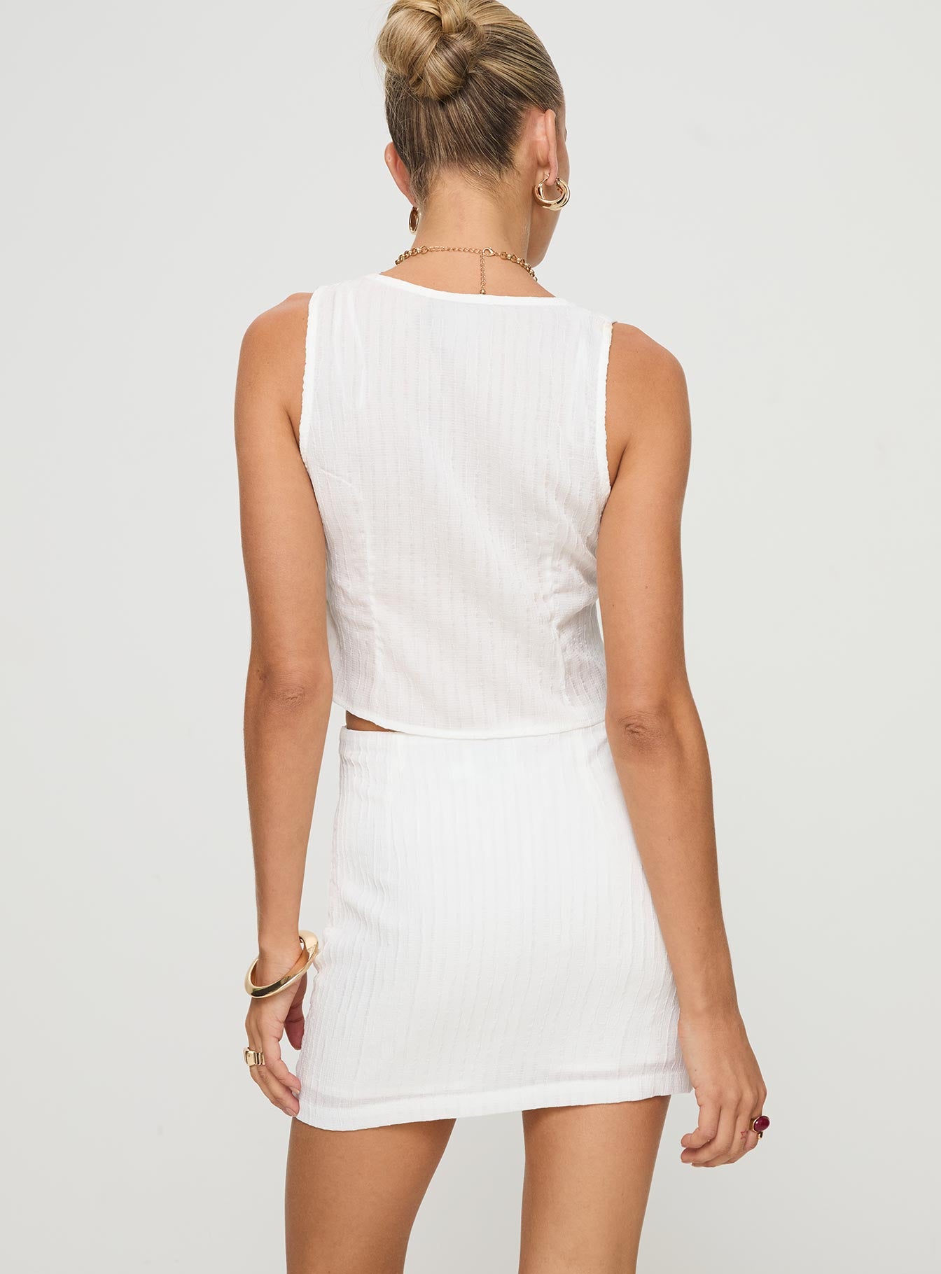 Two piece set Crop top, fixed shoulder straps, v-neckline, button fastening at bust, split hem High-rise mini skirt, invisible zip fastening at side Non-stretch material, fully lined