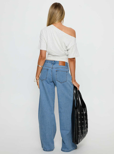 back view of model wearing Princess Polly Supercut Low Rise Baggy Pleat Jeans Light Blue Wash Low Rise Jeans 