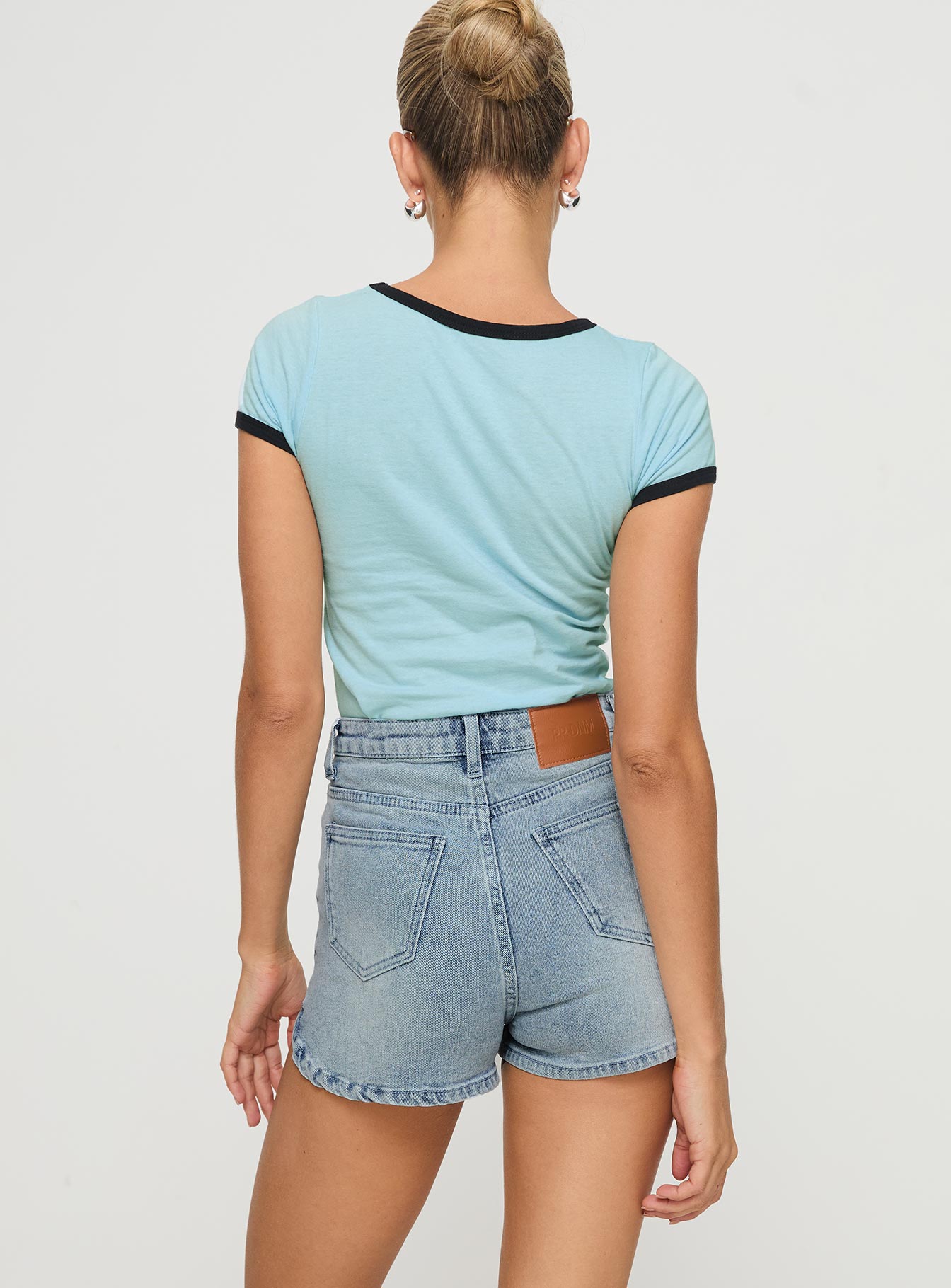 back view of model wearing Princess Polly Richardsons Denim Shorts Light Blue Wash High Waisted Shorts 