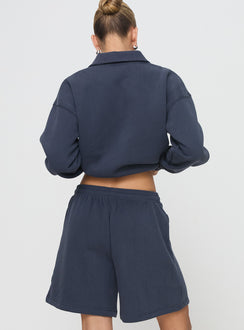 back view of model wearing Princess Polly Dream Fleece Longline Shorts Navy High Waisted Shorts 