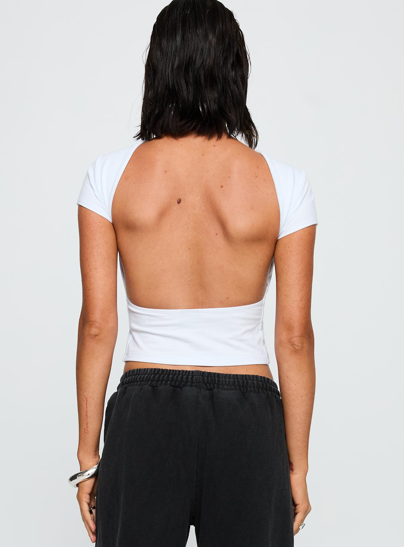back view of model wearing Princess Polly SDSU Comeback Top White Short Sleeves Crew Neck 