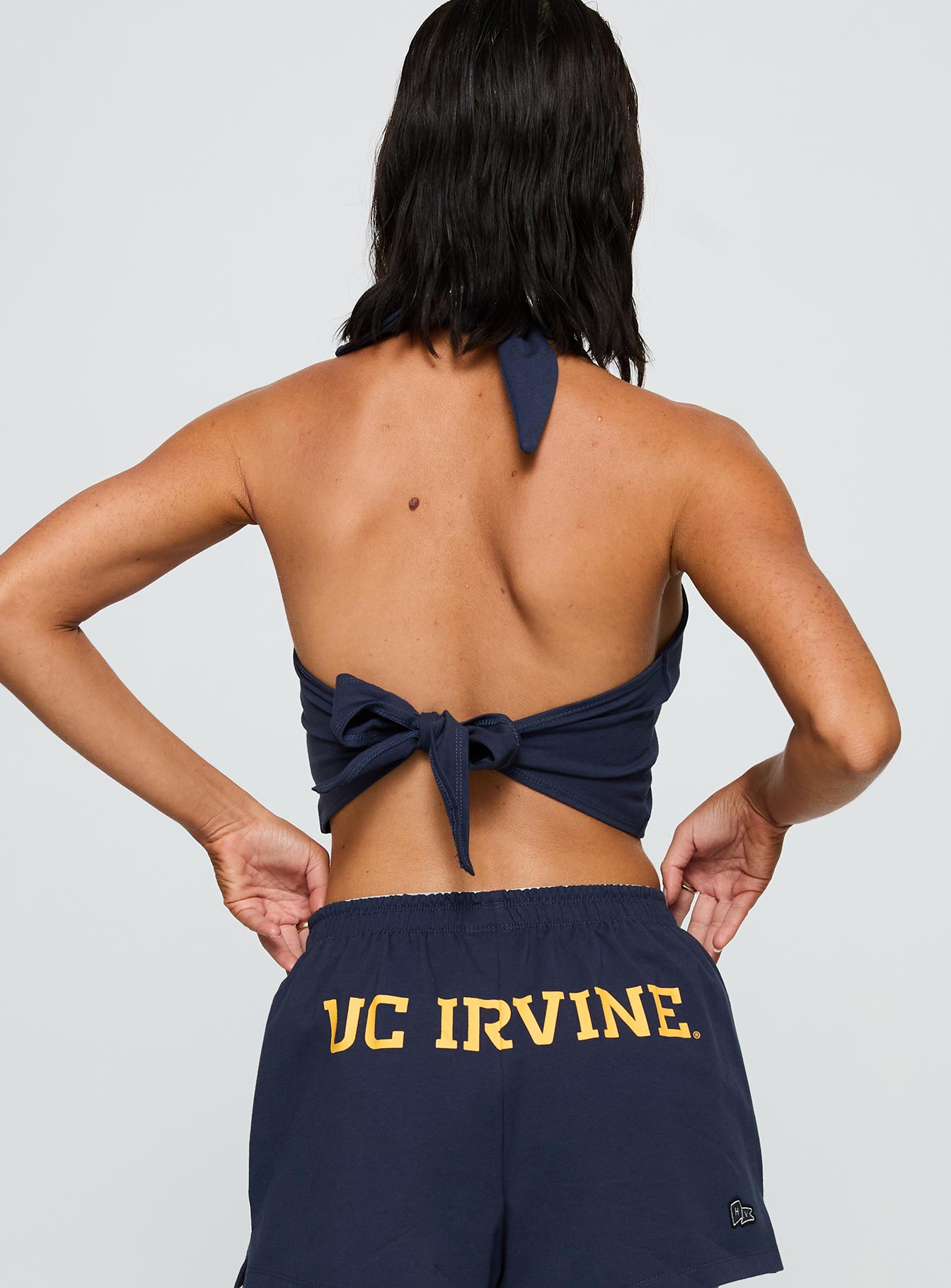 back view of model wearing Princess Polly UC Irvine Tailgate Halter Top Blue Sleeveless Scoop Neck 
