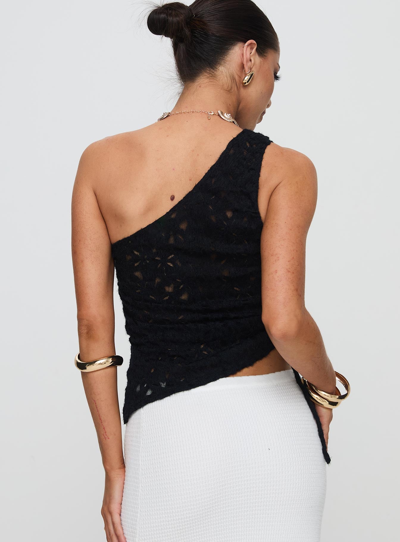 back view of model wearing Princess Polly Sensua One Shoulder Top Black Sleeveless Asymmetric Neckline 