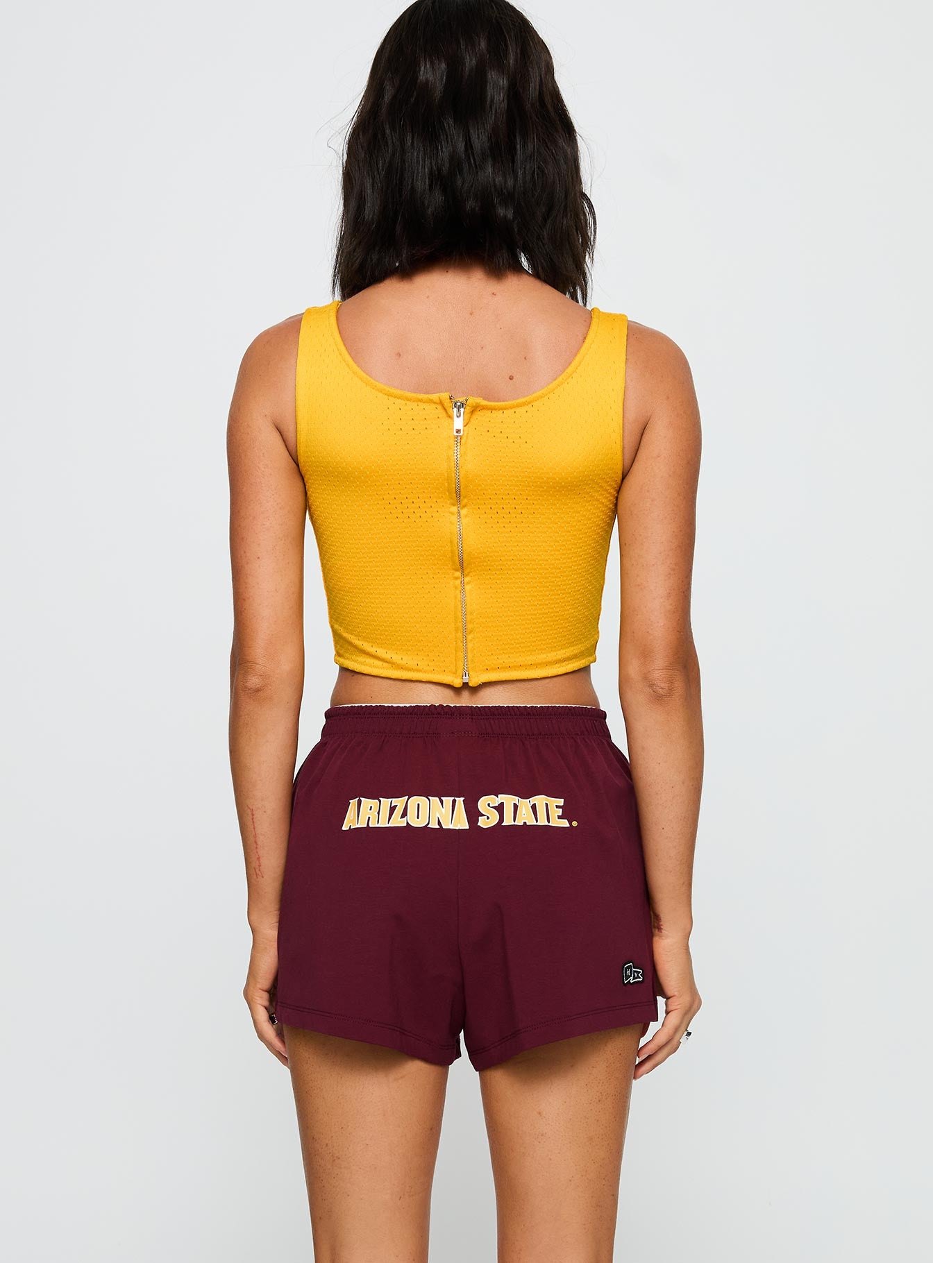 back view of model wearing Princess Polly ASU Soffee Shorts Maroon High Waisted Shorts 