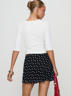 back view of model wearing Princess Polly Dapple Bias Mini Skirt Black Polka Dot Mini Skirts 