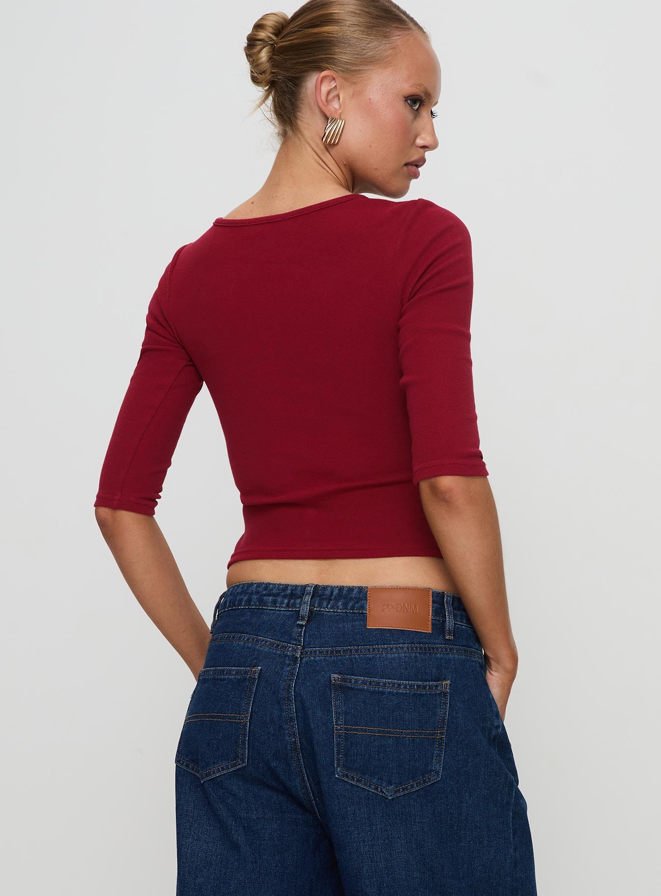 back view of model wearing Princess Polly Elaia 3/4 Sleeve Top Red Three Fourth Sleeves Crew Neck 
