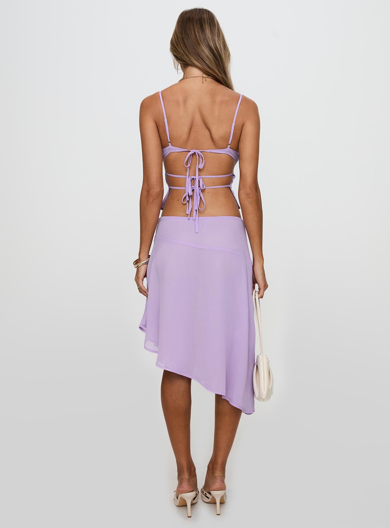 back view of model wearing Princess Polly Pappilion Asymmetrical Skirt Lilac 