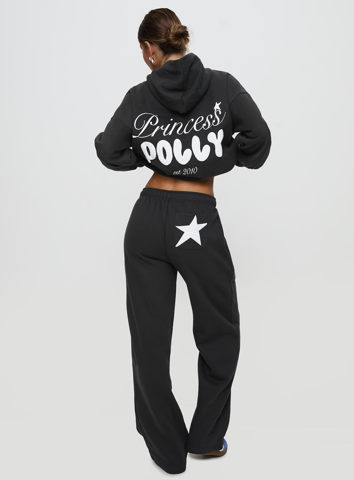 back view of model wearing Princess Polly Princess Polly Wide Leg Track Pant Bubble Script Charcoal High Waisted Pants 