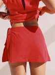 back view of model wearing Princess Polly Gulliver Tie Side Mini Skort Red High Waisted Shorts 