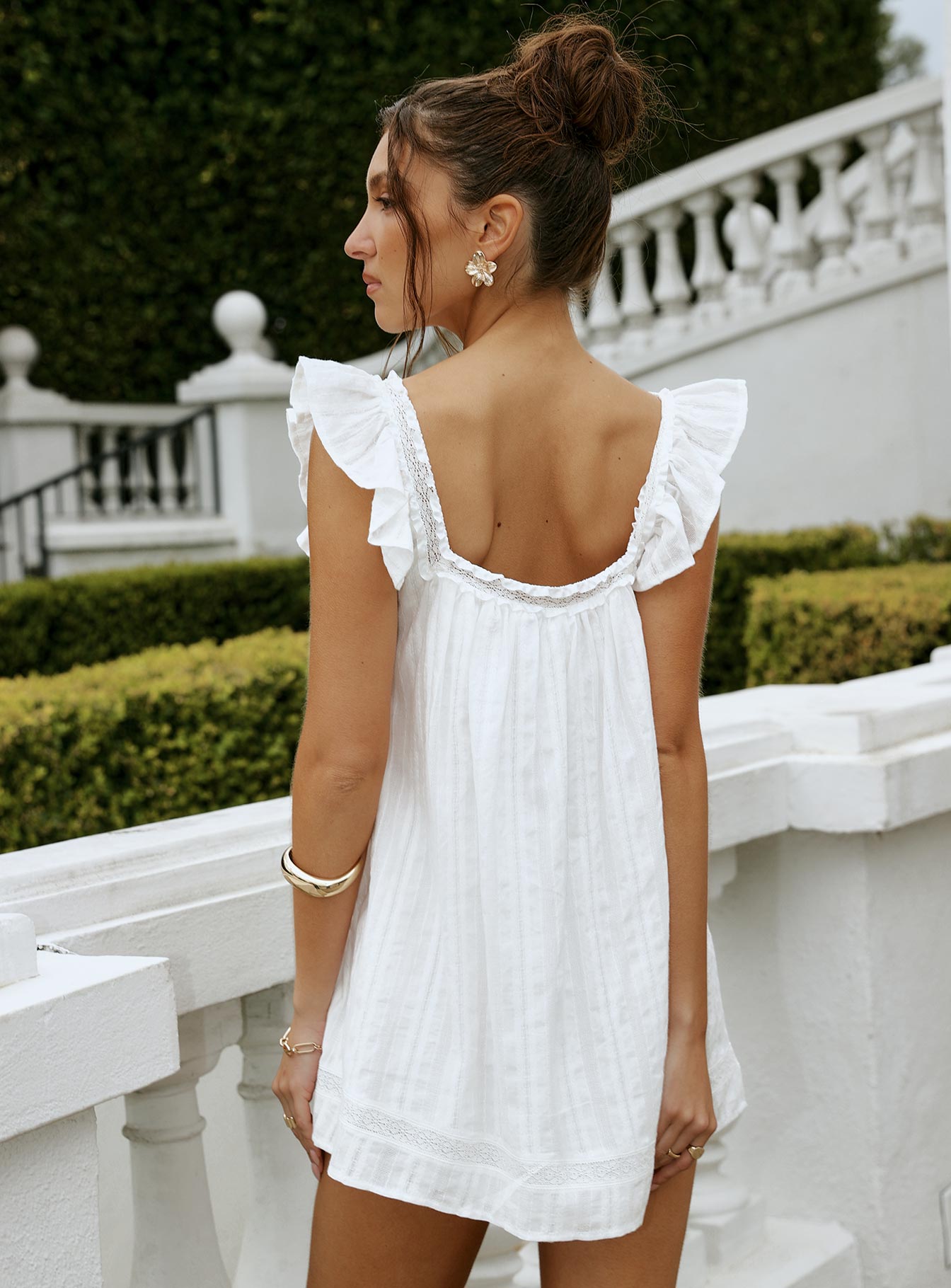 back view of model wearing Princess Polly Summerland Broiderie Mini Dress White Square Neck 