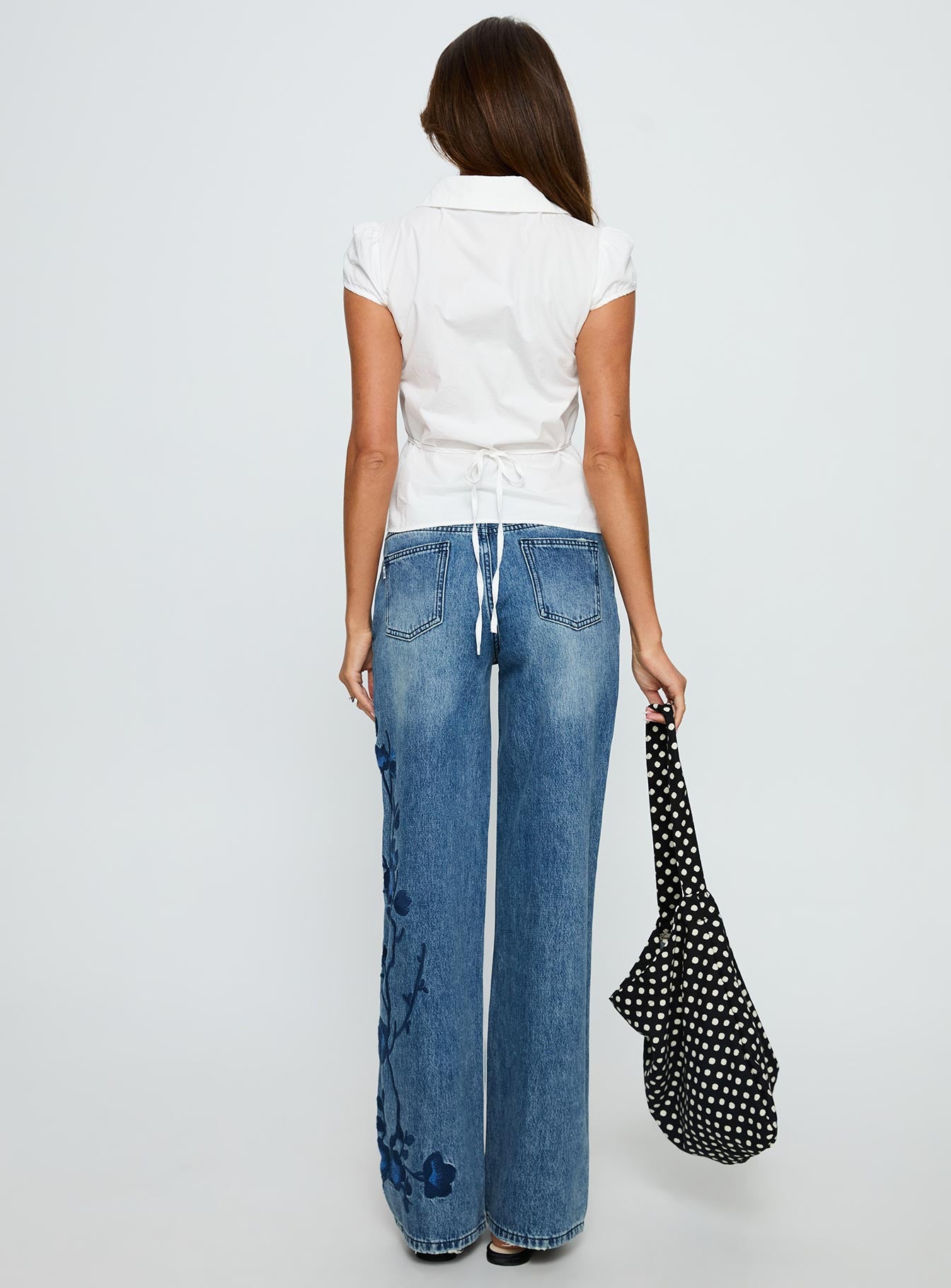 back view of model wearing Princess Polly Sisterhood Mid Rise Wide Leg Patchwork Jeans Mid Blue Wash Mid Rise Jeans 