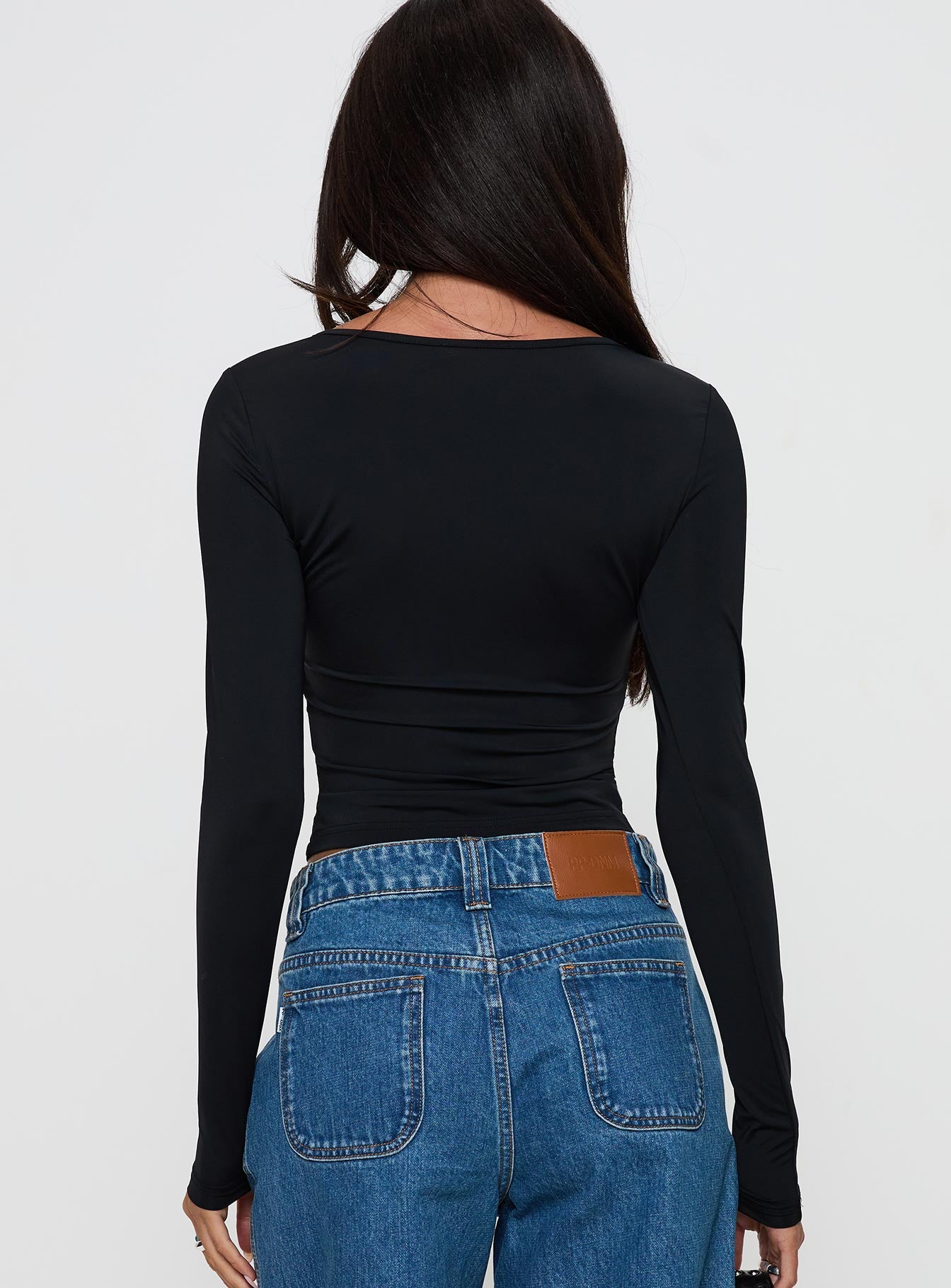 back view of model wearing Princess Polly Layna Long Sleeve Plunge Neck Top Black Full Sleeves V-Neck 