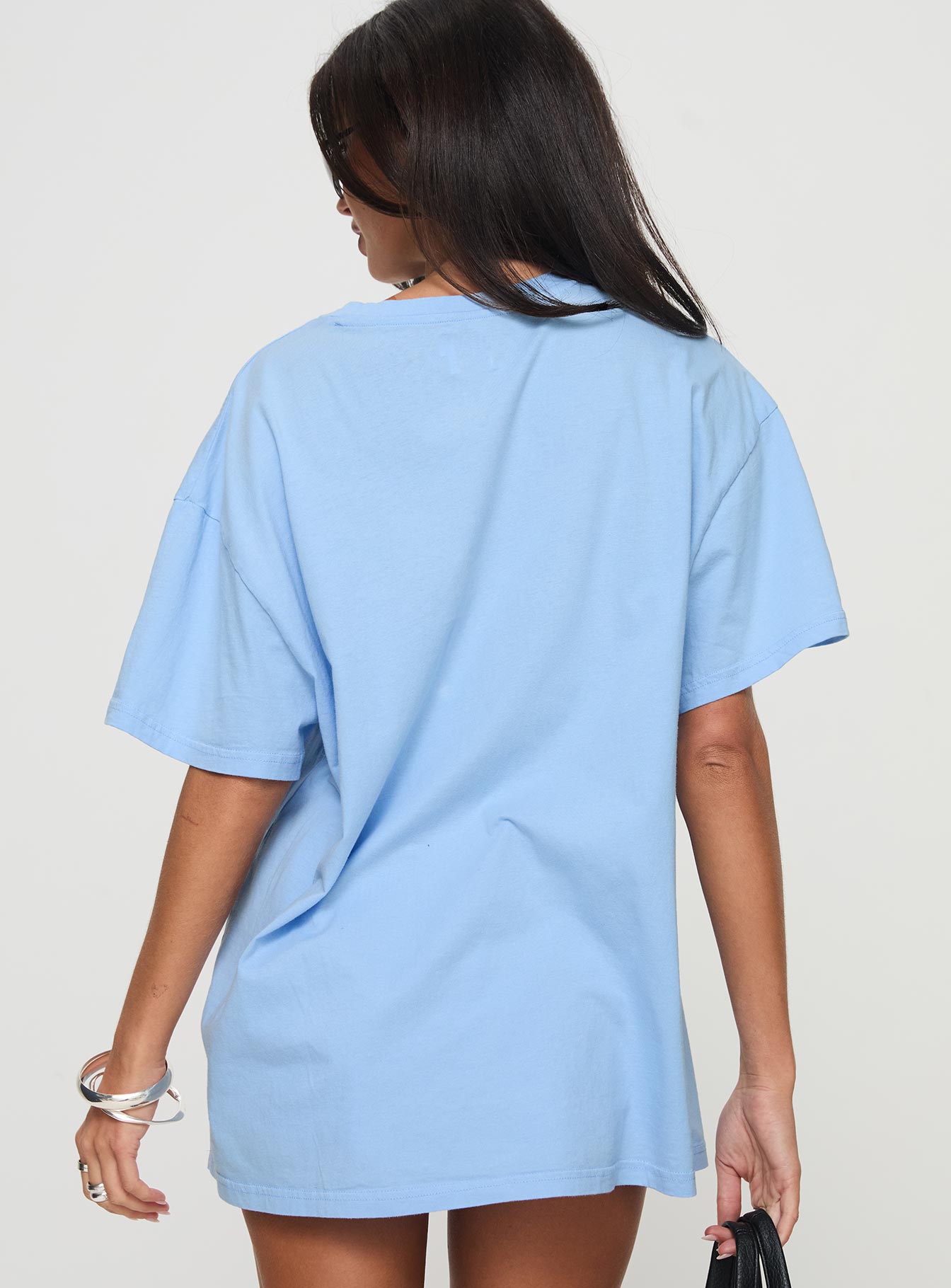 back view of model wearing Princess Polly Races 1996 Oversized Tee Blue Half Sleeves Crew Neck 