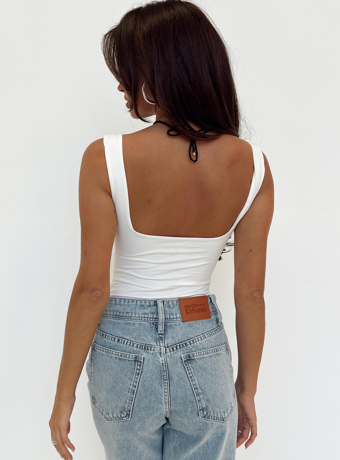 back view of model wearing Princess Polly Rehna Bodysuit White Sleeveless 