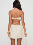 back view of model wearing Princess Polly Luvstruck Strapless Mini Dress Beige Tall Straight Neck 