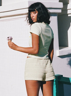 back view of model wearing Princess Polly Pinup Broderie Micro Shorts Cream High Waisted Shorts 