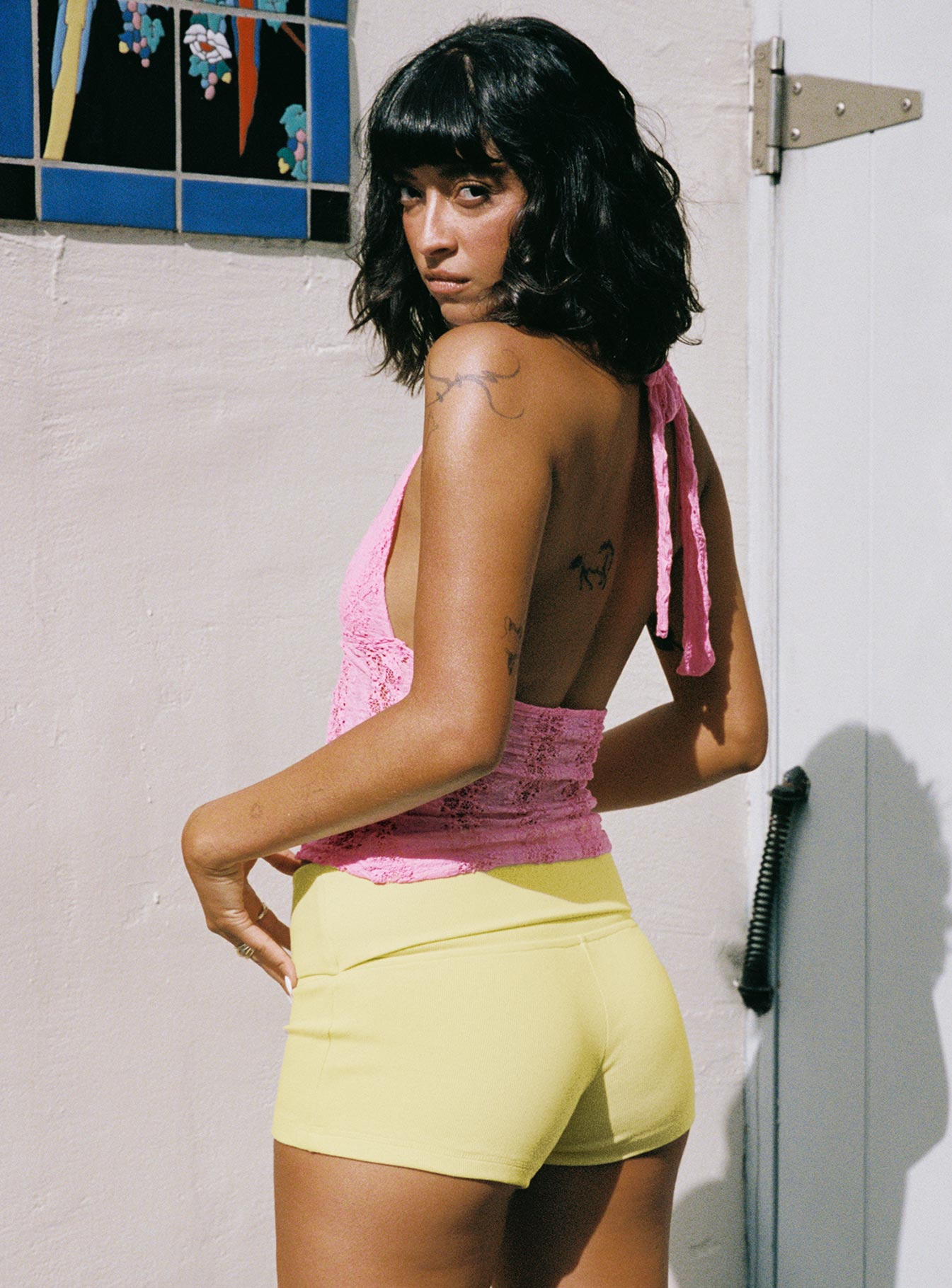 back view of model wearing Princess Polly Cruizer Halter Top Pink Sleeveless Plunger 