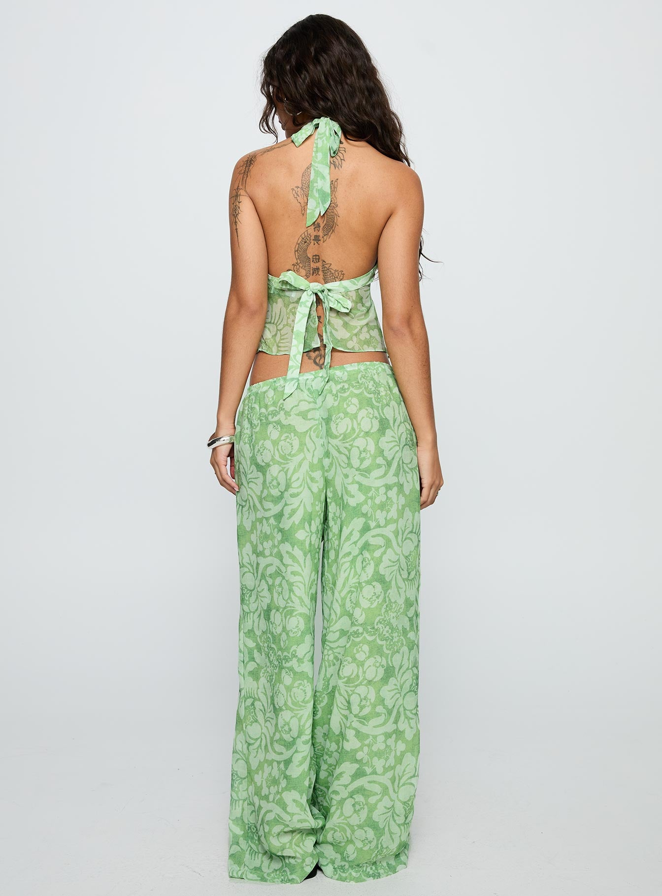 back view of model wearing Princess Polly Finesse Pants Green Floral High Waisted Pants 