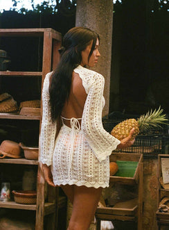 White Long sleeve mini dress Crochet style, high neckline, open back with tie fastening, flared sleeves