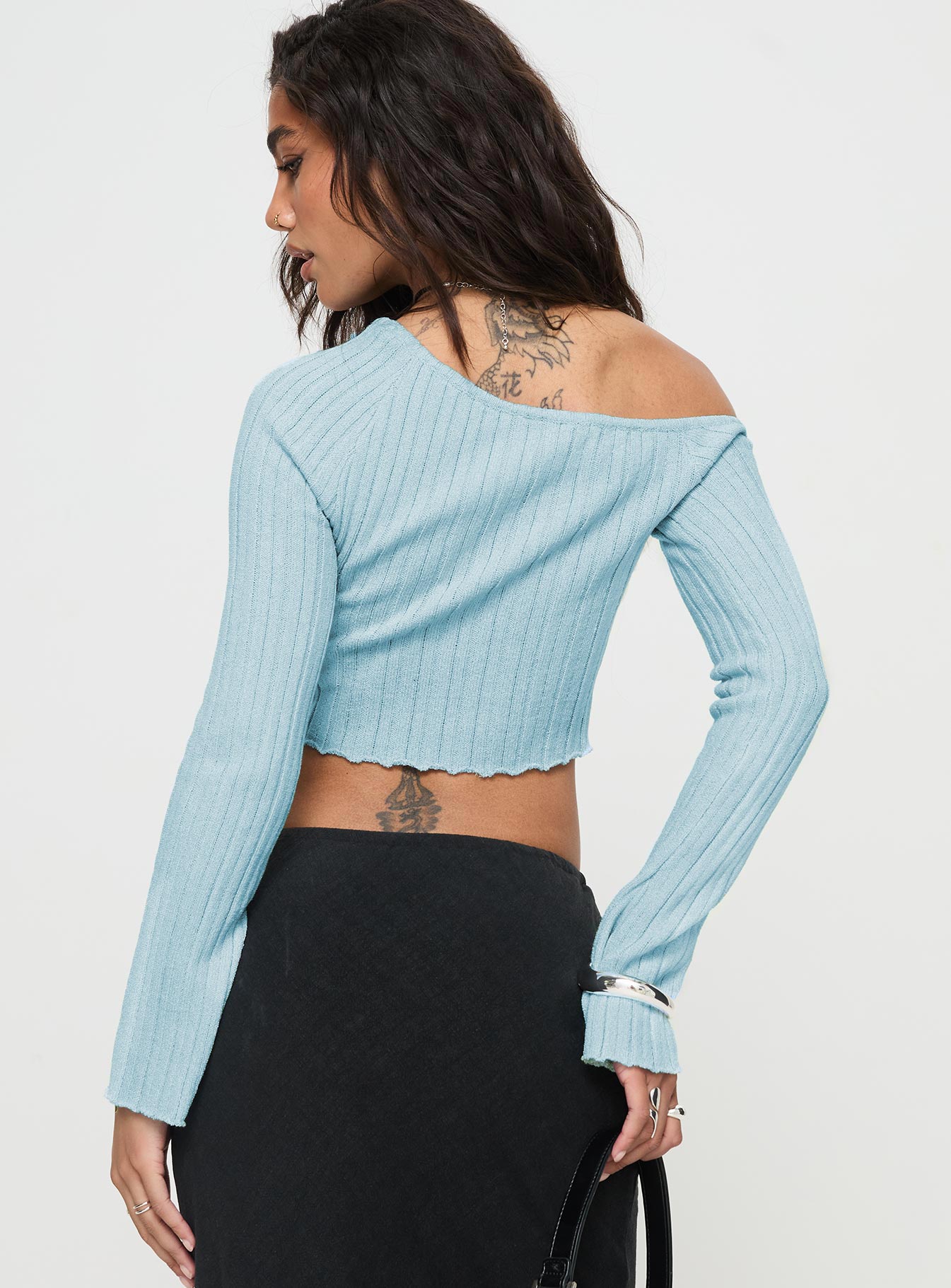 back view of model wearing Princess Polly Santorini Knit Top Blue Full Sleeves Asymmetric Neckline 