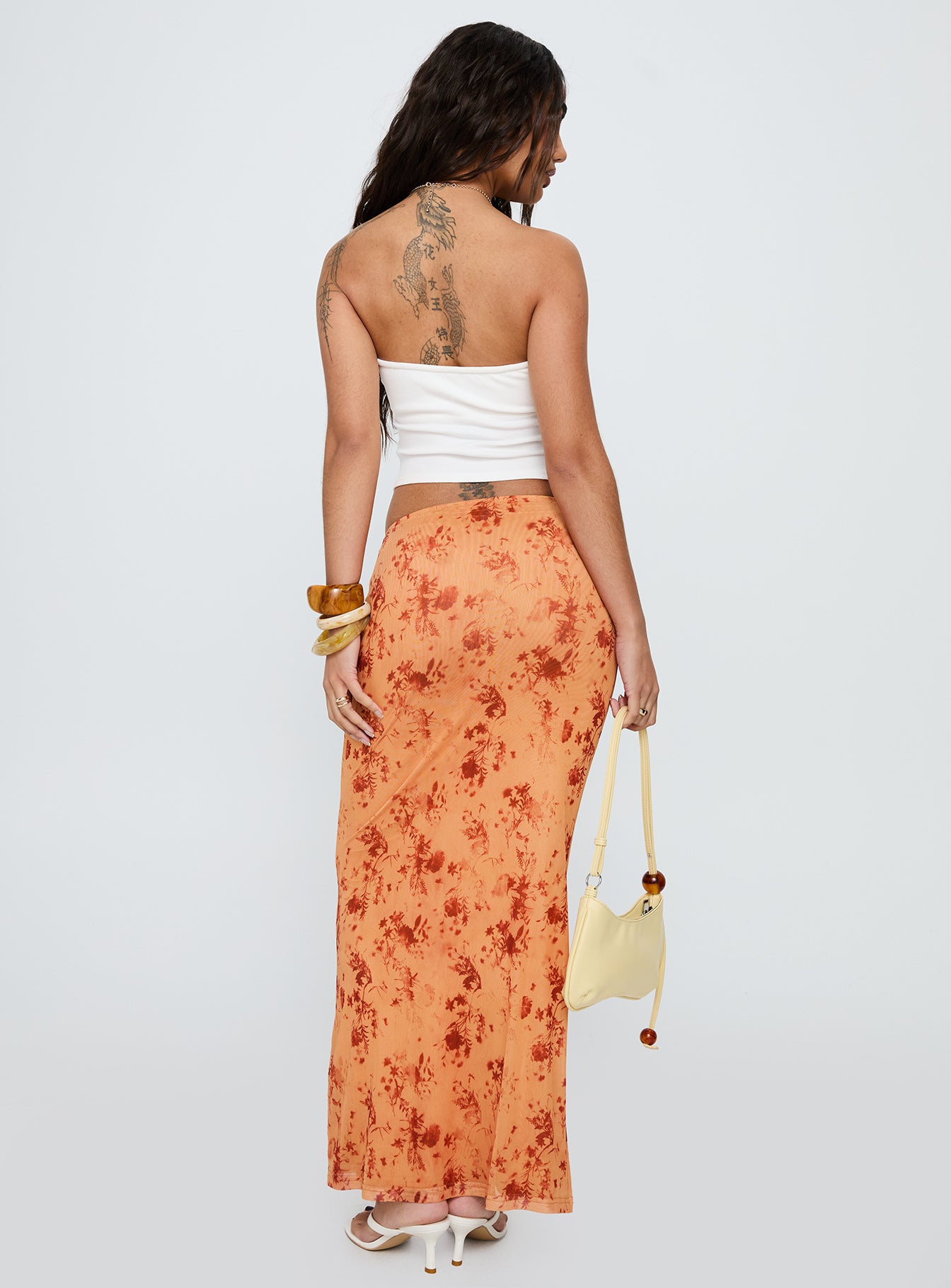 back view of model wearing Princess Polly Shepherd Maxi Skirt Orange Multi Maxi 