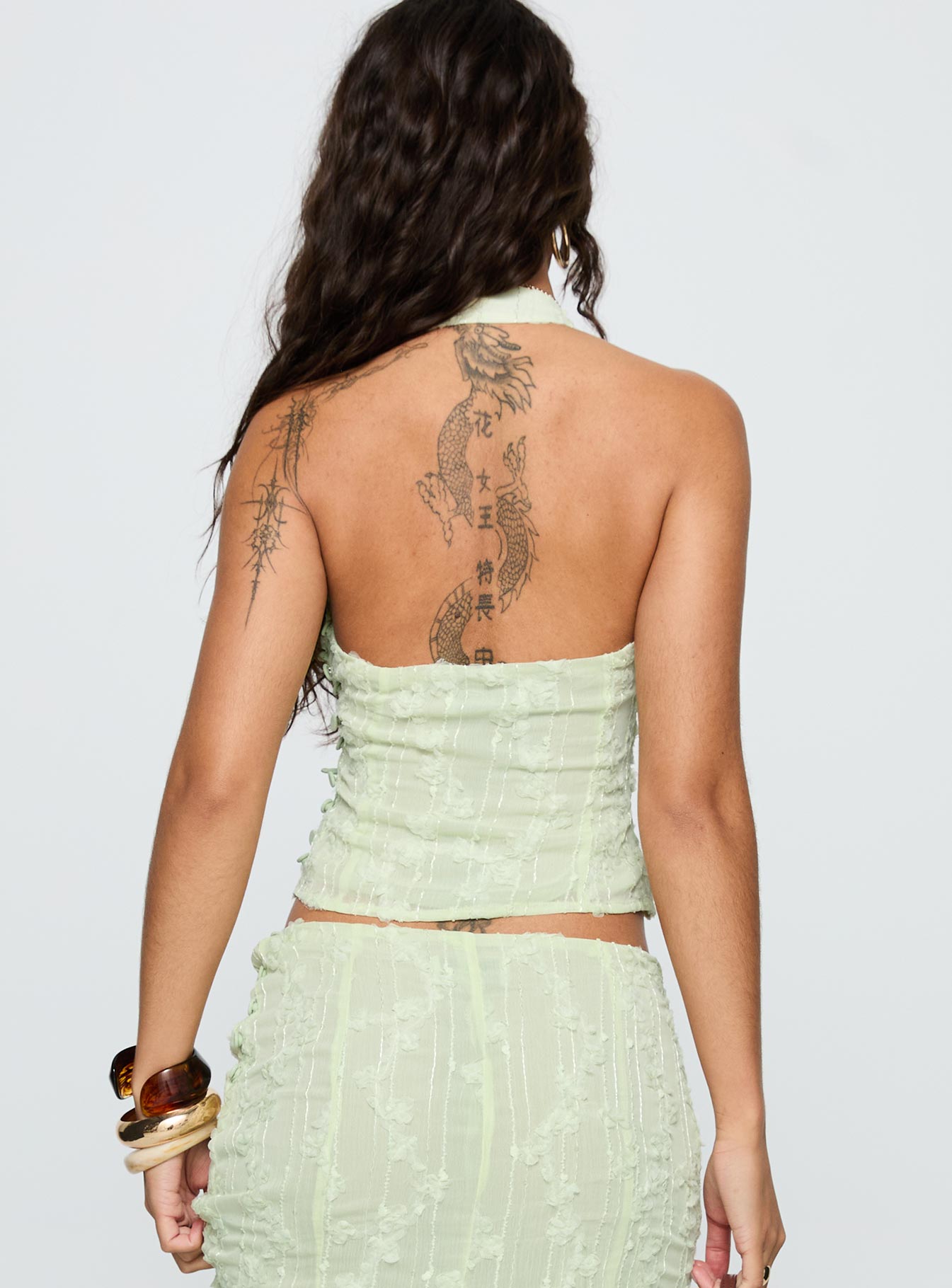 back view of model wearing Princess Polly Aspyn Halter Top Sage Sleeveless Plunger 