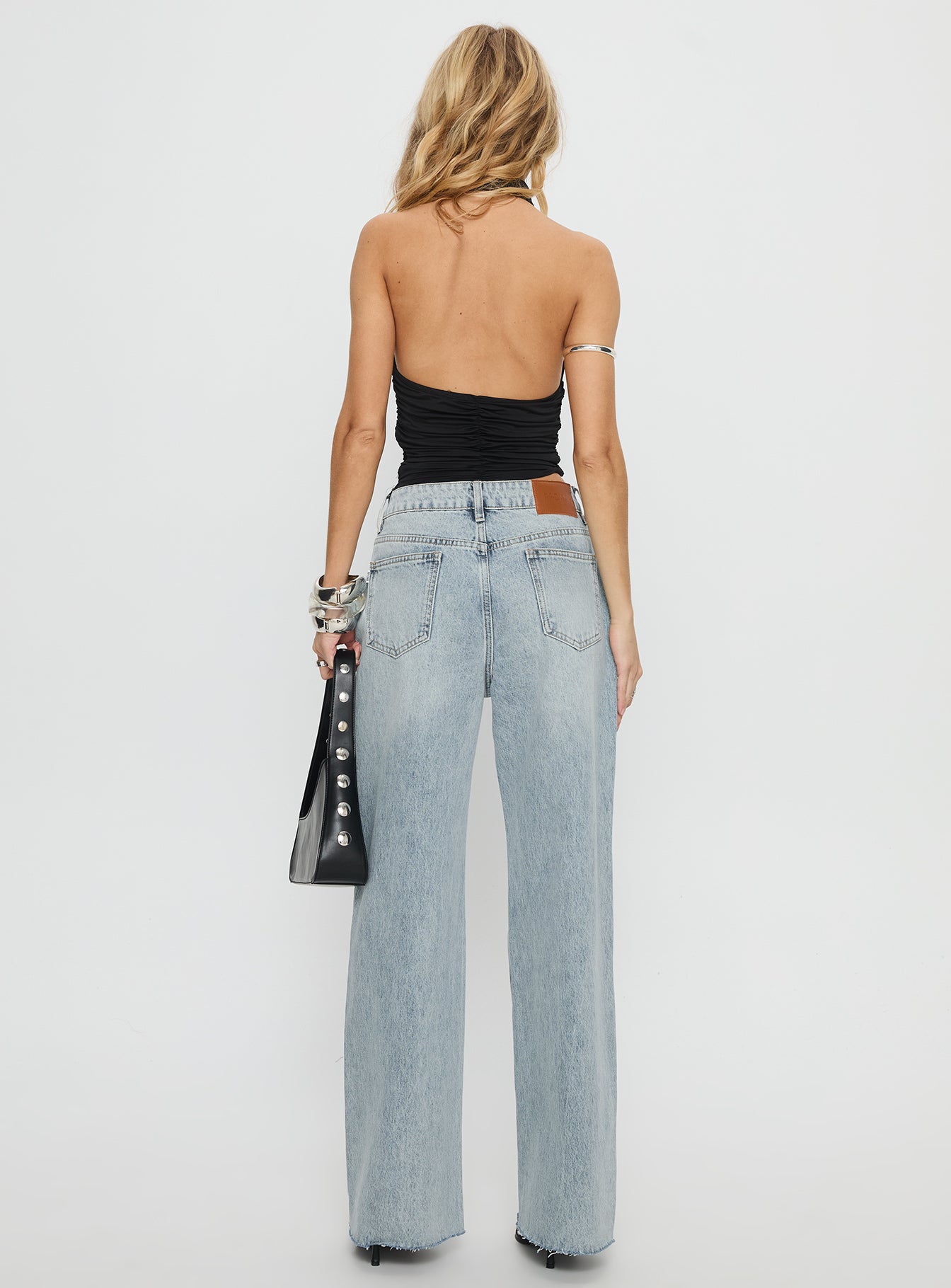 back view of model wearing Princess Polly Henesey High Rise Straight Leg Jeans Light Wash Mid Rise Jeans 