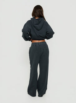 Presenting black Baggy Sweatpant in womens regular pants with wide-leg mid-rise waist back view of model wearing Princess Polly