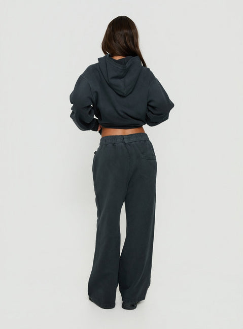 Presenting black Baggy Sweatpant in womens regular pants with wide-leg mid-rise waist back view of model wearing Princess Polly