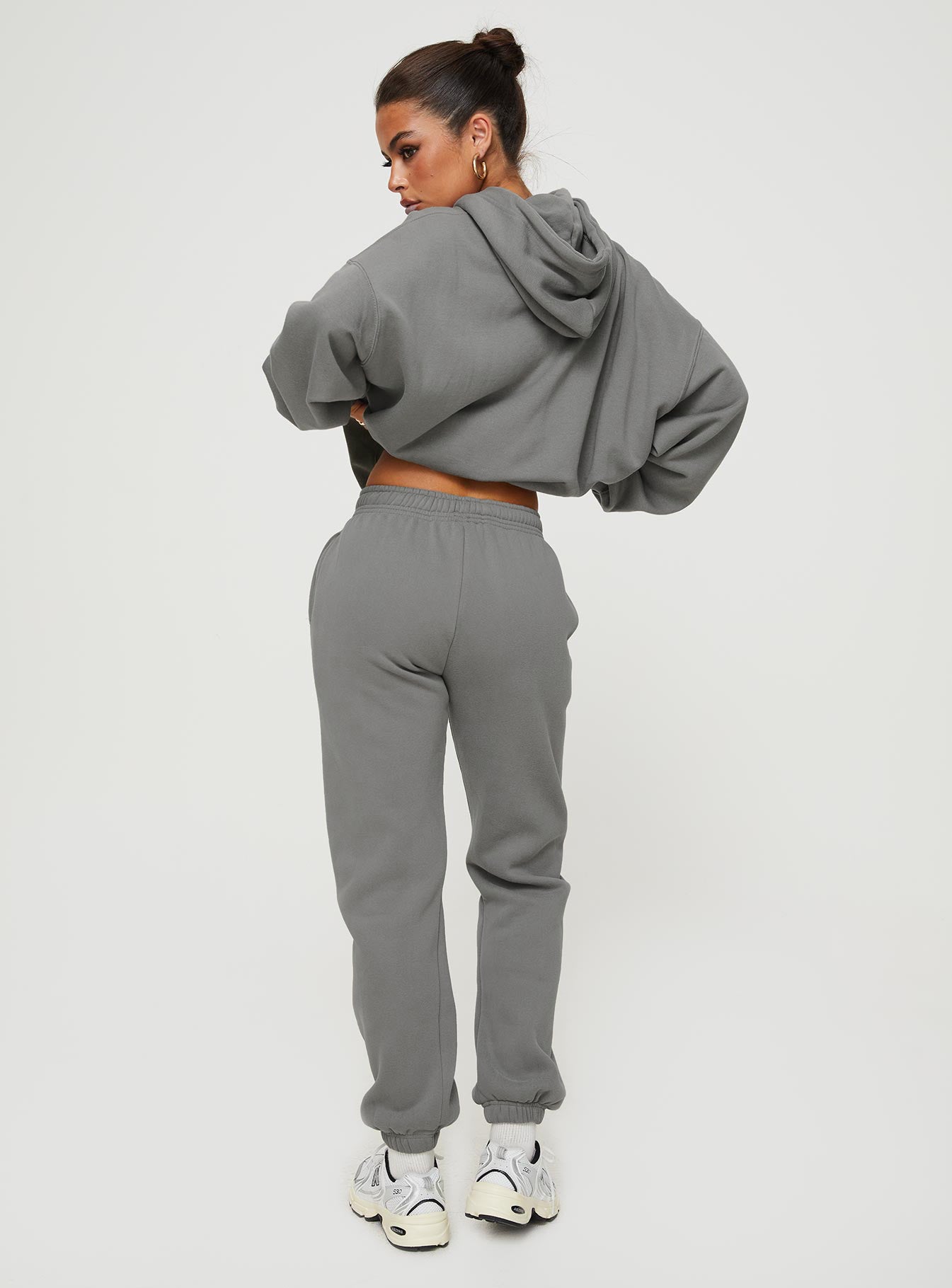back view of model wearing Princess Polly Princess Polly Track Pants Bubble Text Charcoal / Light Pink Mid Rise 