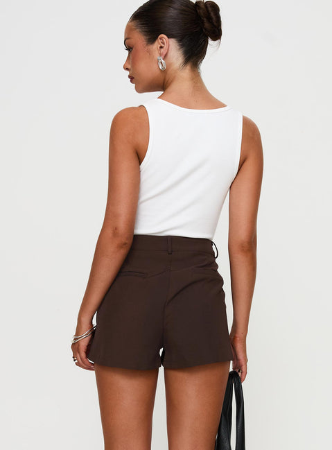 back view of model wearing Princess Polly Ellerie Tailored Shorts Chocolate High Waisted Shorts 