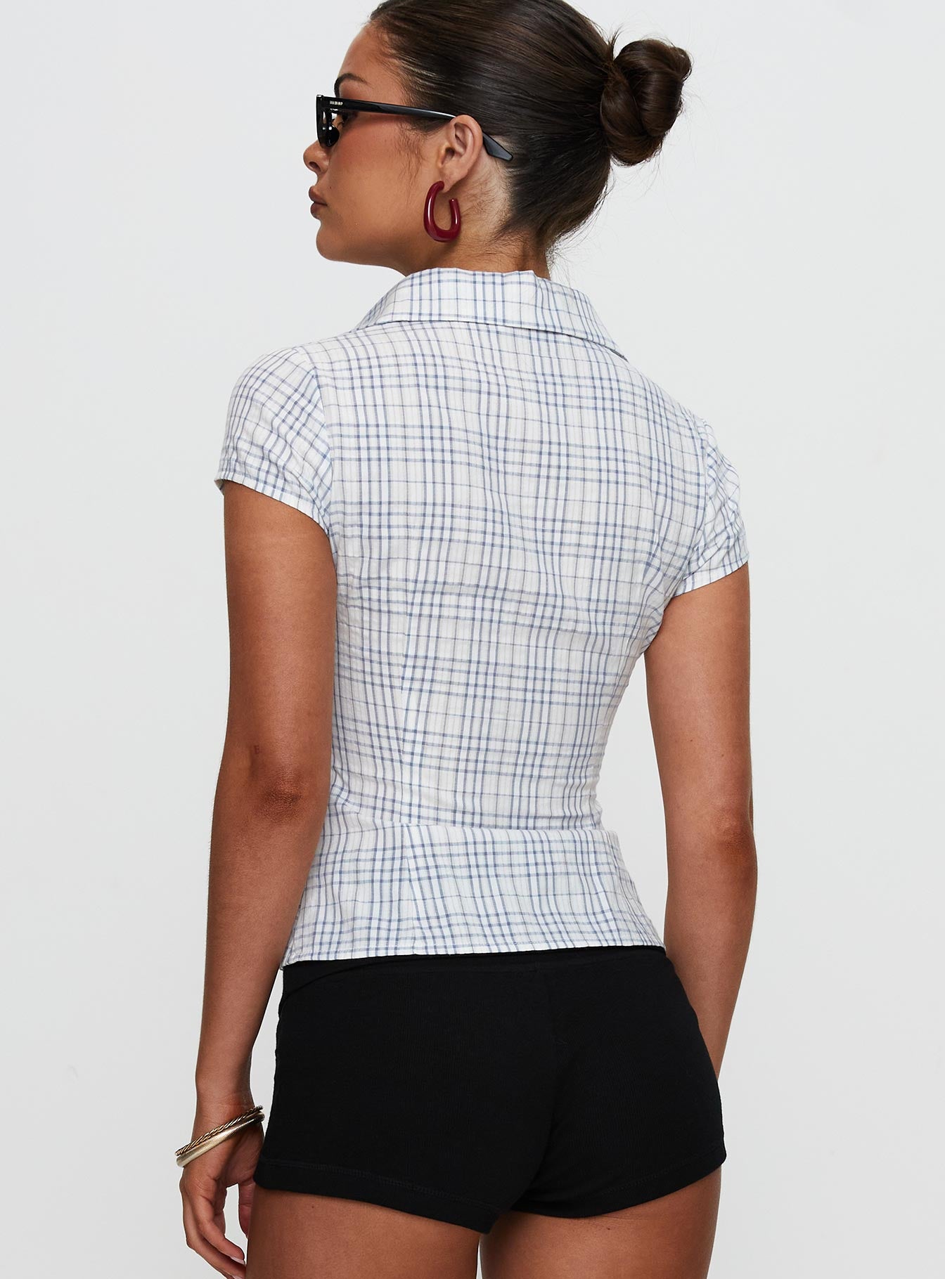 back view of model wearing Princess Polly Cottesloe Blouse Top Blue Check Short Sleeves V-Neck 