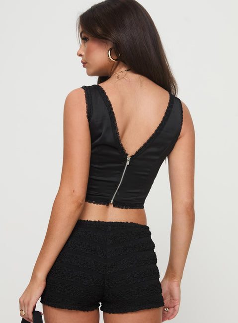 back view of model wearing Princess Polly Pointing Top Black Sleeveless Plunger 