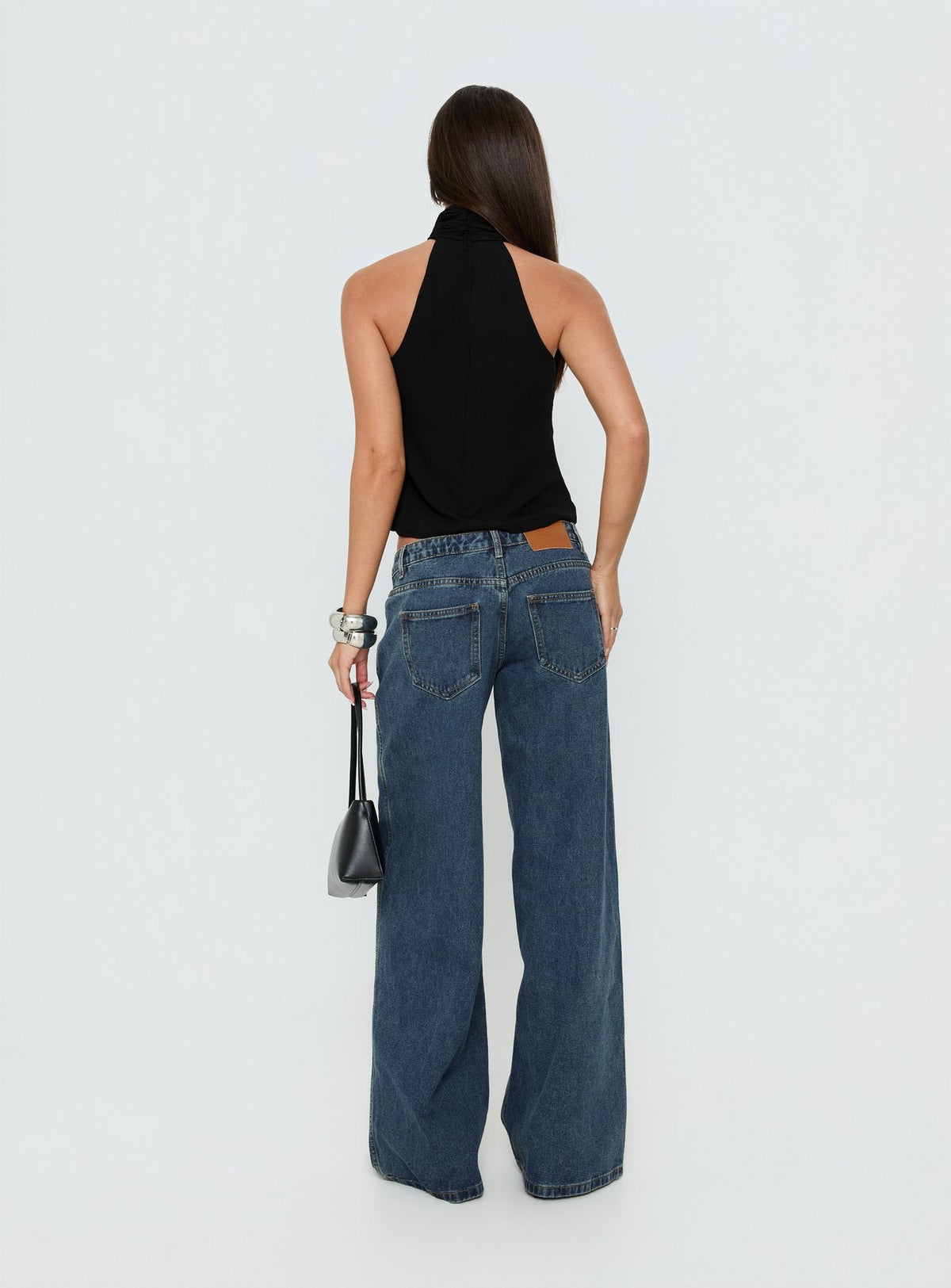 Designed with Picco Ultra Low Rise Wide Leg Jeans womens-jeans in dark blue wash back view of model wearing Princess Polly