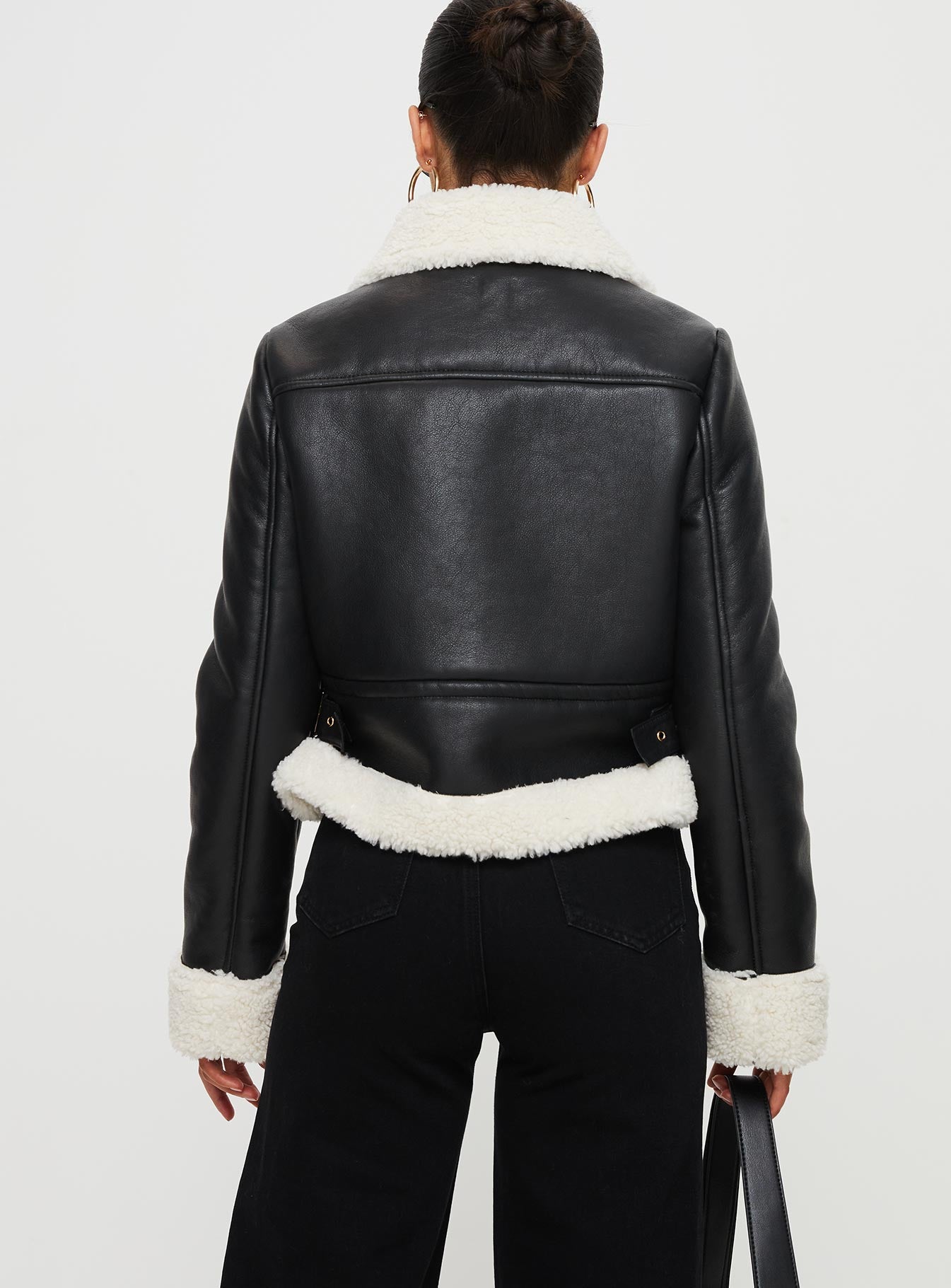 Jacket Faux leather, shearling material on inside and outside, classic collar, twin chest pockets, twin buckle detail at sides-adjustable Zip fastening at front