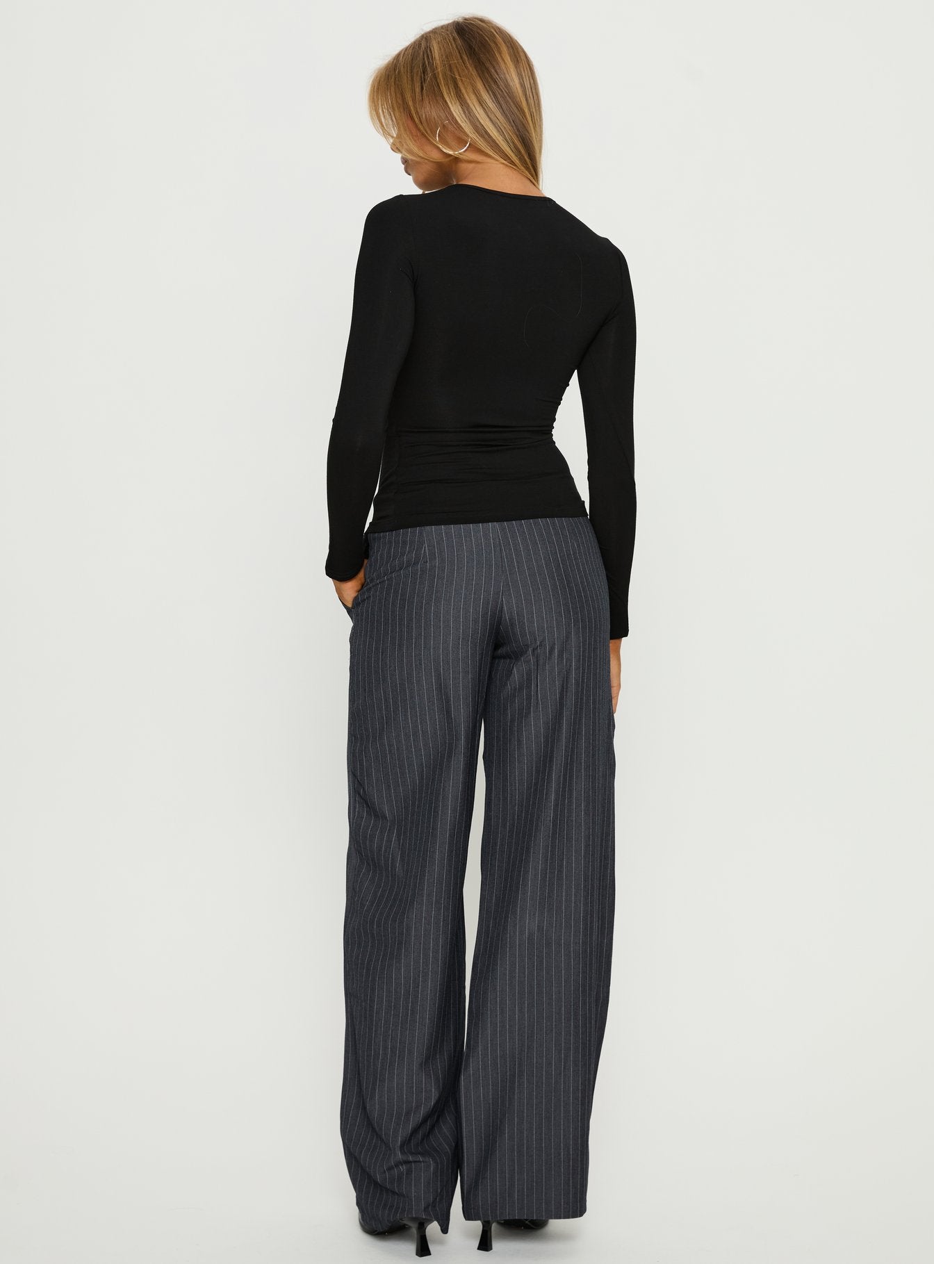 back view of model wearing Princess Polly Khane Low Rise Wide Leg Pant Charcoal Pinstripe Mid Rise Pants 