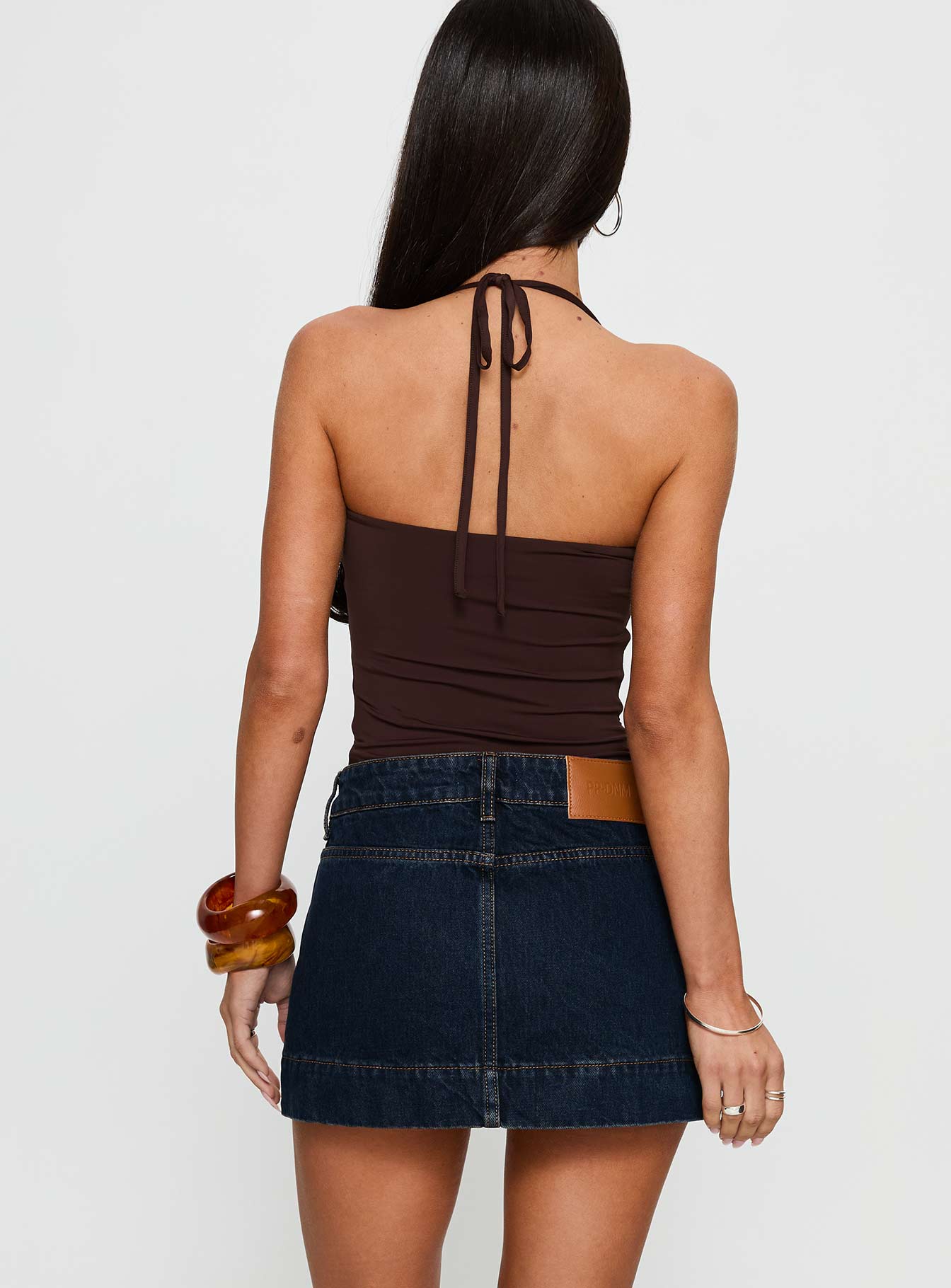back view of model wearing Princess Polly Warna Low Rise Denim Mini Skirt Dark Wash Mini Skirts 