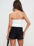 back view of model wearing Princess Polly Symphony Denim Skort Washed Black Tall Low Rise Shorts 