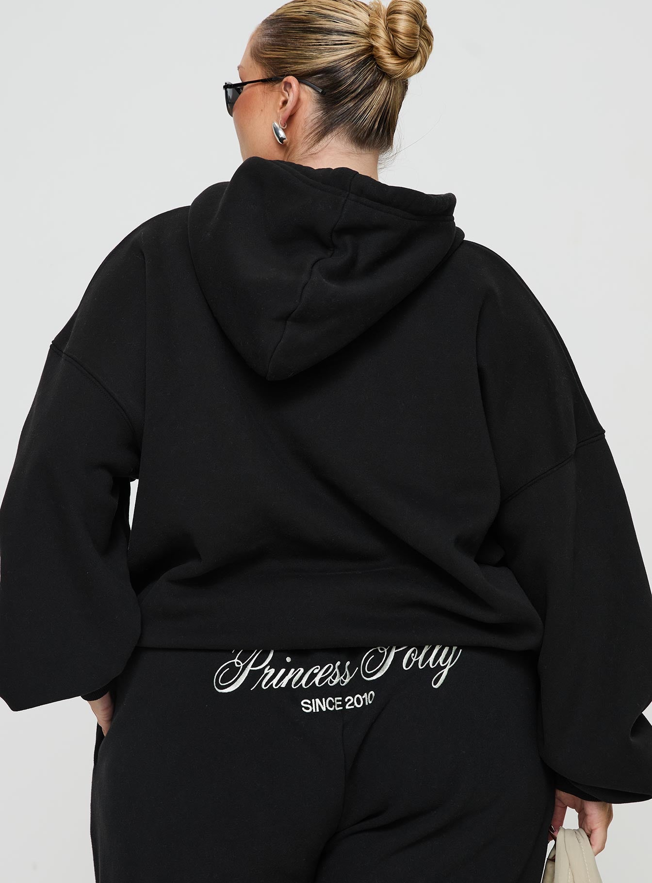 back view of model wearing Princess Polly Princess Polly Hooded Sweatshirt Script Black / Ivory Curve 