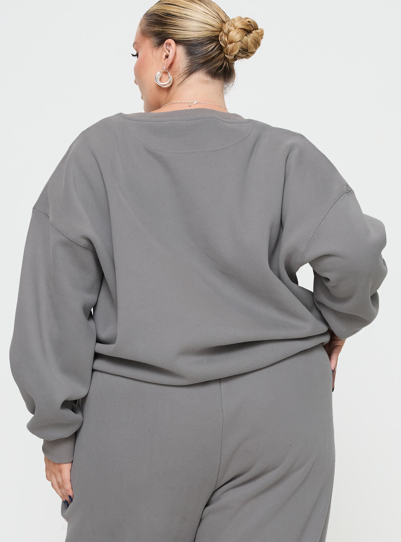 back view of model wearing Princess Polly Princess Polly Crew Neck Sweatshirt Puff Text Charcoal Curve 